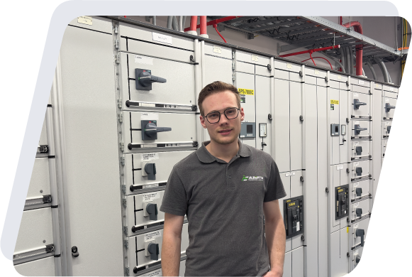 Foto van Alain Alberts, inspecteur bij Alberts Elektro naast een verdeelkast.
